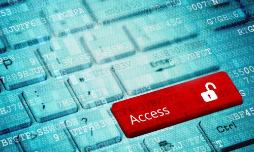 Red key with text Access and open padlock icon on white laptop keyboard.