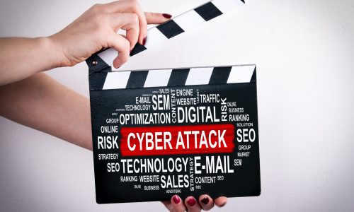 Cyber Attack concept. Female hands holding movie clapper.